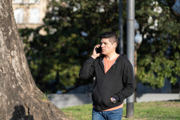 Man talking on cell phone in a park