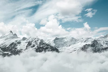 Digital composition of Mönch und Jungfrau mountains covered by white clouds