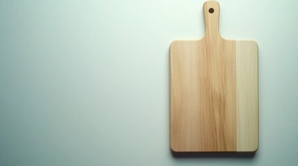 Fototapeta premium A wooden cutting board with a handle, isolated on a white background.