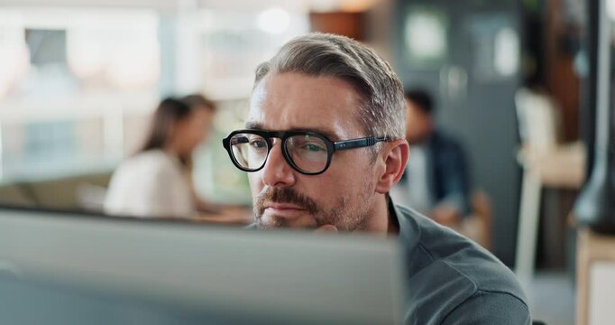 Computer, glasses and reading with business man in office for administration, report or research. Desktop, programming and thinking with mature employee in creative workplace for web development