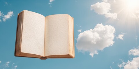 Open book floating against a clear sky with fluffy clouds, inspiration and creativity.