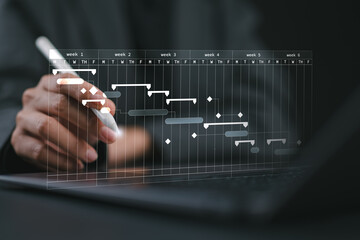 Project management concept. Site manager working with Gantt chart schedule to plan tasks and...