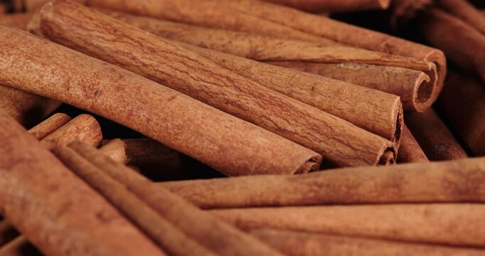 Cinnamon sticks rotate as a background. Fragrant cinnamon close-up. Spices with cinnamon. Food cooking video concept.