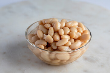 Glass Bowl of White Beans on Marble Surface