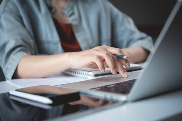 Close up, woman hand typing on laptop computer keyboard. Business woman online working on laptop...