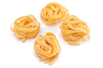 Four Classic Italian Raw Egg Fettuccine - Isolated on White Background. Dry Twisted Uncooked Pasta. Italian Culture and Cuisine. Raw Golden Macaroni Pattern - Isolation