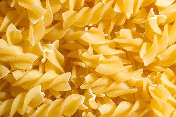 Uncooked Fusilli Pasta: A Culinary Canvas of Spiral Macaroni, Creating a Lively and Textured...
