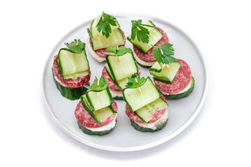 Canapes without Bread with Salami, Cucumber, Greens and Cream Cheese on White Plate - Isolated on White. Easy Breakfast. Diet Food. Quick and Healthy Sandwiches. Healthy Snacks with Tasty Fillings
