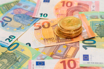 A Stack of Bitcoin Coins on the Euro Banknotes. Money Saving, Cryptocurrency, Blockchain and Anonymous Payments Concept
