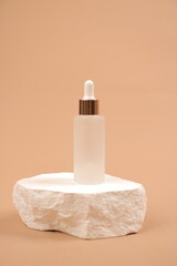 Frosted Glass Dropper Bottles with Natural Stone Aesthetic on Neutral Beige Background