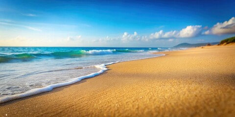 Fototapeta premium Sandy beach with blurred ocean in the background, summer, beach, sand, ocean, blurred, sunny, relaxation, vacation, coastline