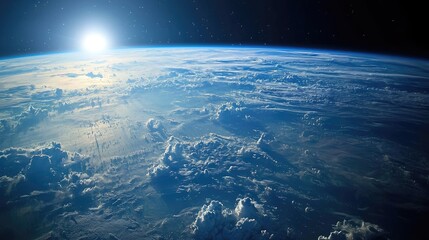 Fototapeta premium Sunrise over Earth from space, showing the blue planet, clouds, and the sun.