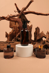 Amber Glass Pump Bottles on White Pedestal with Rustic Wooden Background