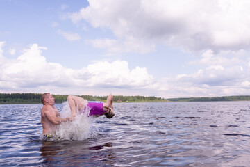 Kids with dad frolic in the water on a hot sunny summer day