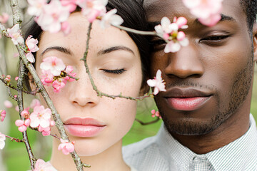 Obraz premium close portrait of a young Biracial woman as she gently opens her eyes, a young Black man nearing with flowers, aesthetic people