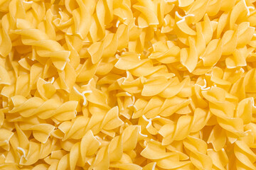 Uncooked Fusilli Pasta: A Culinary Canvas of Spiral Macaroni, Creating a Lively and Textured...