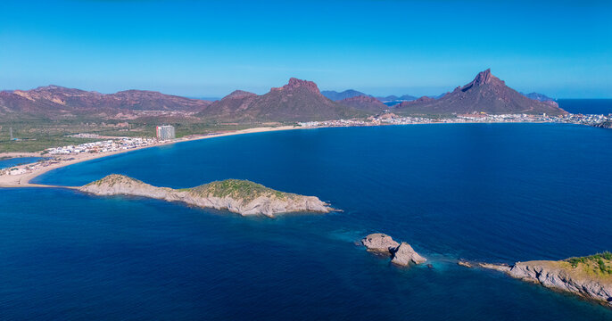 Aerial photo of Los Algodones beach in San Carlos Sonora, Mexico. The islands full of sahuaros stand out. An iconic contrast between desert and sea. In the background the rocky mountain Tetakawi.