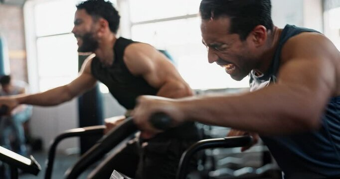 Men, high five and exercise bike at gym for cycling, fitness and happy for progress, strong and partnership. People, friends and machine for training, workout and cardio with laugh, speed or wellness