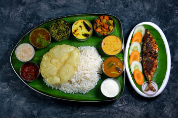 Traditional South Indian Thali with Indian mackerel fish Fry and Assorted Dishes. Different...