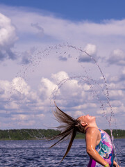 A girl frolics in the water on a hot sunny summer day