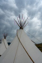 Flap Pole Curves Up The Side Of Teepee Under Cloudy Sky