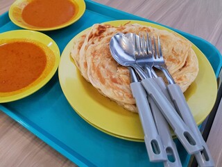 Asian food roti canai prata. Malaysia traditional food roti canai prata with curry . Asian food...