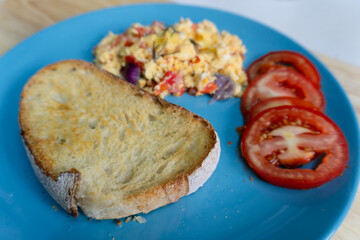 A delicious plate of breakfast served with a variety of eggs and vegetables, fresh salad