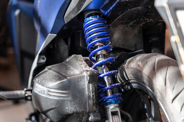 Obraz premium shock absorber of motorcycle in garage . back view
