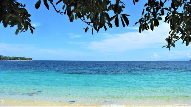 Blue sky day in Pasir Putih Manokwari, Papua, Indonesia. A beautiful quiet beach, only the sound of wave is heard, bright blue sky, full of memory