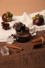 Amber Glass Jar with Mangosteen, Cinnamon, and Natural Decor on Textured Fabric Background
