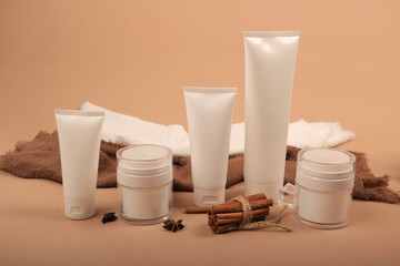 White Cosmetic Tubes and Jar with Cinnamon and Rustic Pinecone Decor