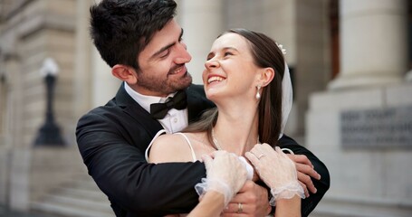 Wedding, happy and couple hug in city for love at ceremony, celebration and commitment. Romance, bride and groom or man and woman in town for promise, partnership and marriage at courthouse