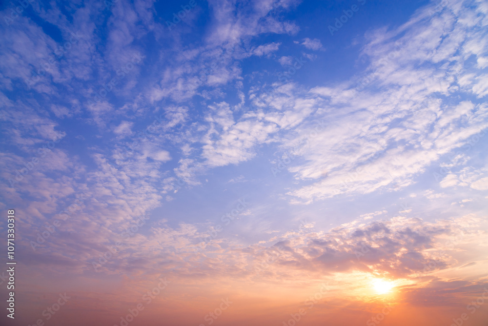 Wall mural sunset sky with rays of light shining clouds and sky background and texture