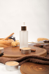 Frosted Glass Dropper Bottle with Natural Spa Elements on Wooden Tray