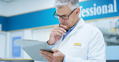 Mature man, doctor and thinking with clipboard for medical study, research or prescription at pharmacy. Male person, pharmacist or healthcare employee in wonder for new medication or drug trial