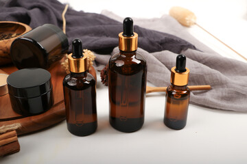 Amber Glass Dropper Bottles with Rustic Decor on Wooden Tray for Skincare and Aromatherapy