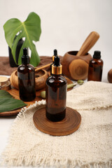 Amber Glass Dropper Bottle with Wooden Spa Bowls and Natural Decor