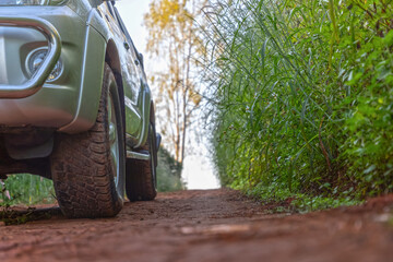 Off-road car travel on mountain roads in woodland forest landscape.
