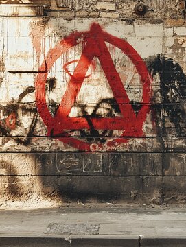 A vibrant mural of defiance and liberation, showcasing the spirit of anarchism through dynamic graffiti on an urban backdrop.