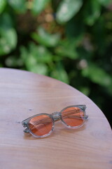 stylish glasses photographed on a wooden table with beautiful bokeh