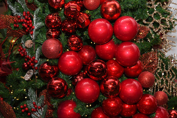 Red Christmas balls on the background of the tree. World tradition Christmas decorations