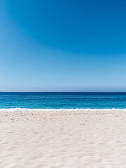 Fototapeta premium Calm beach with golden sand and clear blue ocean under a sunny sky during midday hours