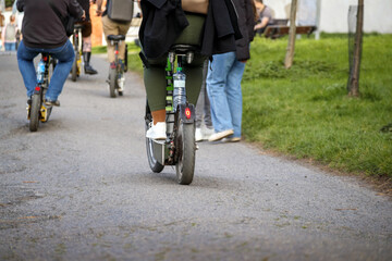 Naklejka premium persons riding an electric bicycle on the street