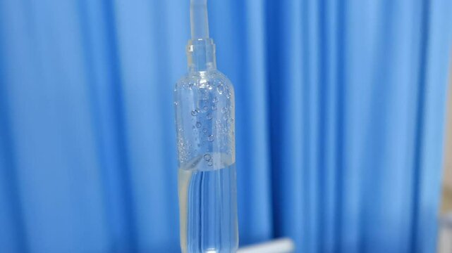 iv drip drops into the patient's room Closeup Saline solution or NSS fluid from IV bag NSS iv dripping tube infusion pumping in hospital chemotherapy.Concept life insurance,medical and healthcare