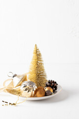 Christmas still life with Xmas tree, decoration like balls, garland, ribbone, ine cone at white backgroud