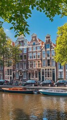 Obraz premium Panorama of famous dancing houses on river Amstel, water channels with house boats