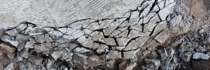 Panoramic image. Closeup of the broken concrete slab at construction site