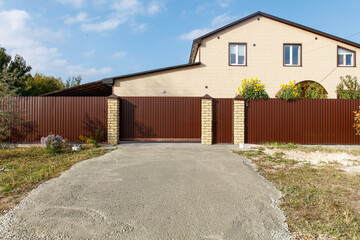 A house with a brown fence and a white door