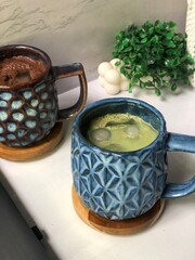 Matcha and chocolate drinks are served in aesthetic glasses