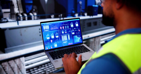 African Worker Inspecting Power Plant Engine